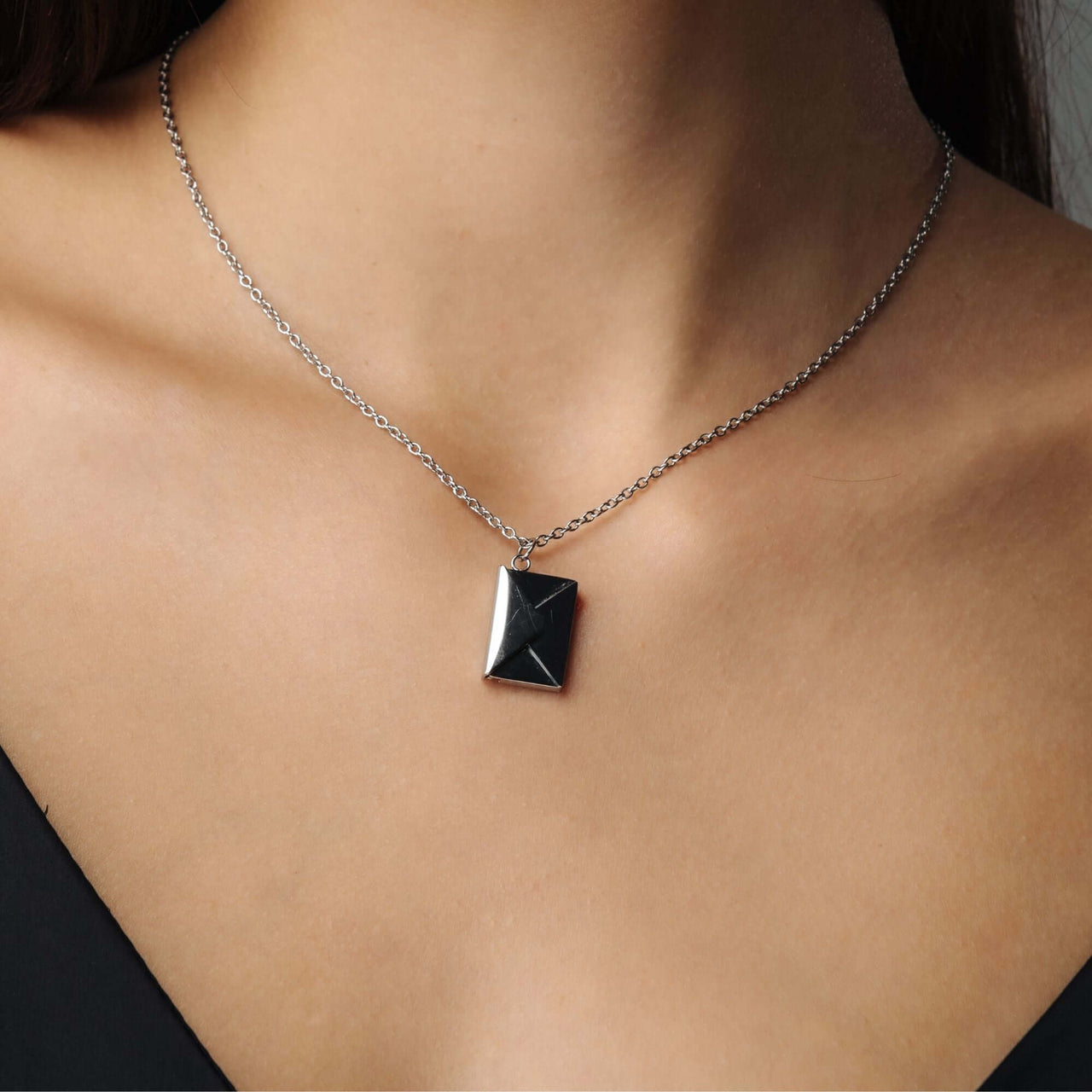 Envelope Name Necklace by Brother & Sisters, featuring a sleek engraved envelope pendant on a silver chain.