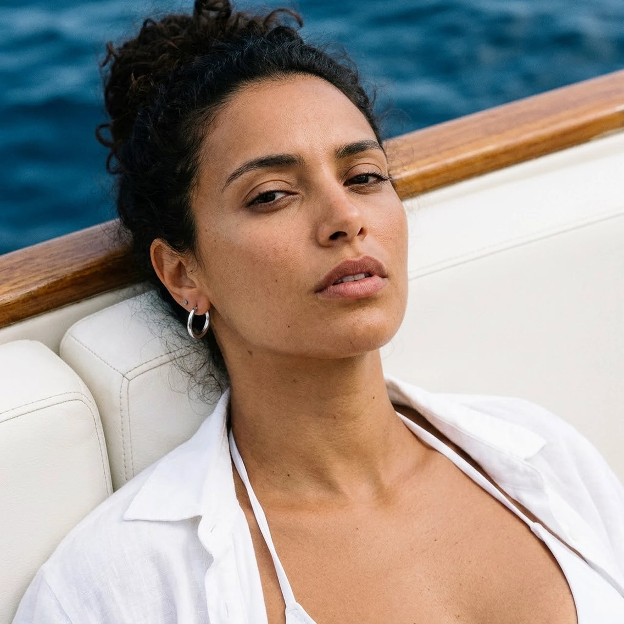 Everyday Waterproof Hoops in Silver, worn on a yacht | SKU: 41001-silver