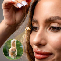 Thumbnail for Close-up of a woman holding an Eye Photo Necklace with a cat projection, showcasing personal keepsake features by Brother & Sisters.