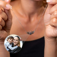 Thumbnail for Flying Heart Photo Necklace held by a woman, featuring a personal photo, from Brother & Sisters.