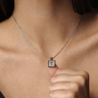 Thumbnail for Glitter Initial Necklace by Brother & Sisters on a woman, showcasing a sparkling letter 'T' charm.