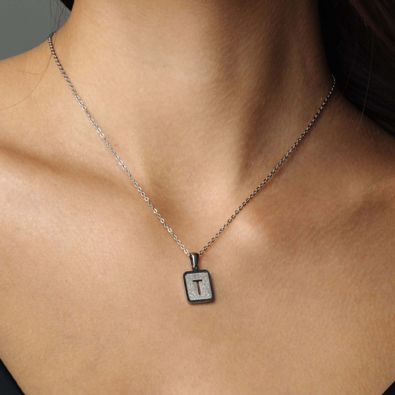 Glitter Initial Necklace by Brother & Sisters featuring a sparkling letter pendant on a silver chain.