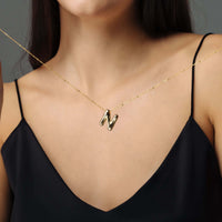 Thumbnail for Essential Initial Necklace displayed on a model, featuring a gold 'N' initial, by Brother & Sisters.
