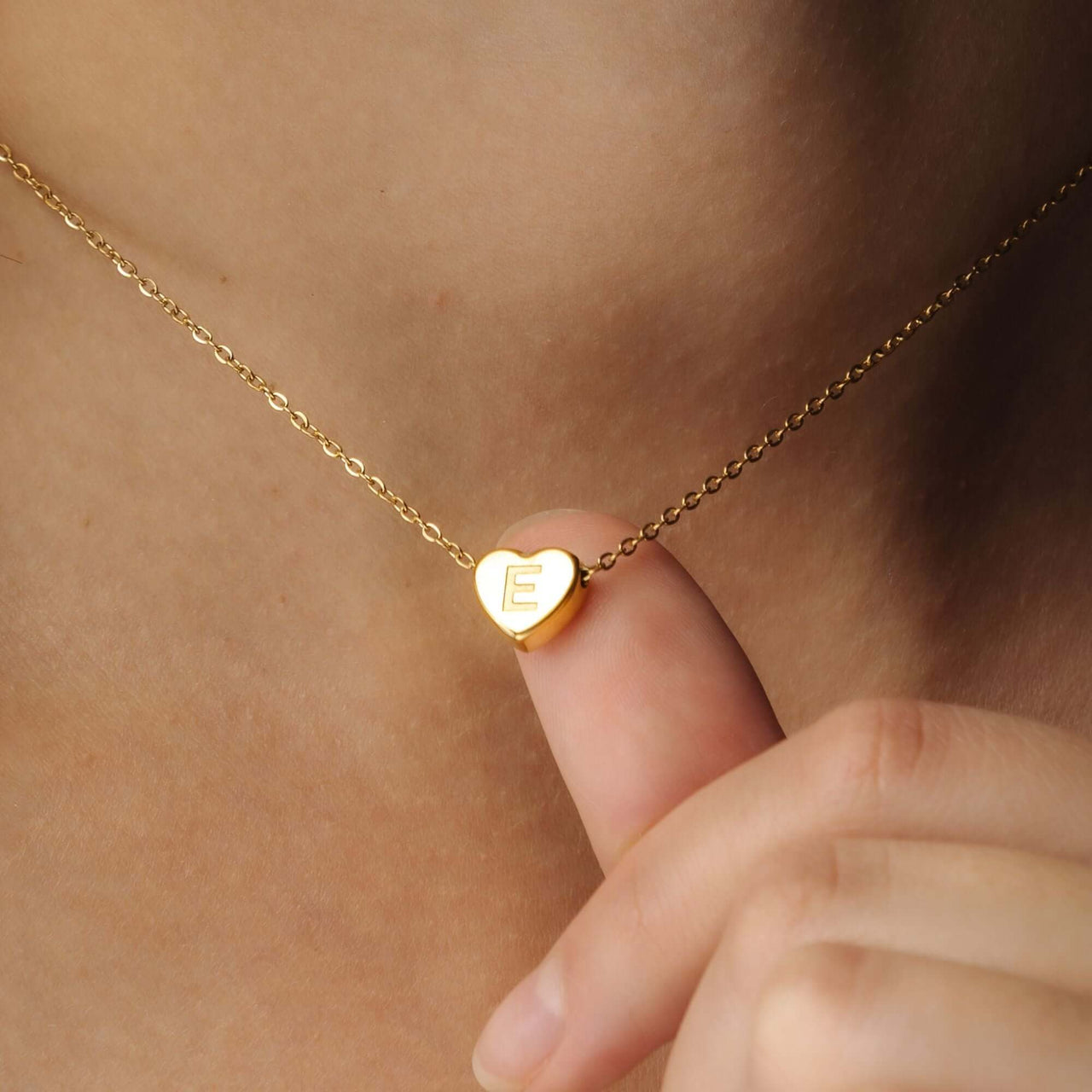 Love Initial Necklace by Brother & Sisters featuring a gold heart charm with initial E.