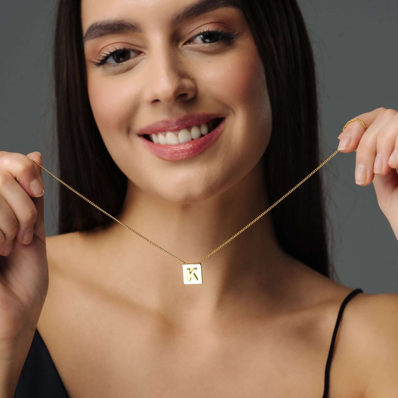 Rectangle Initial Necklace worn by a woman, showcasing minimalist elegance by Brother & Sisters.