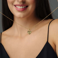 Thumbnail for Sentimental Initial Necklace worn by a woman, featuring a gold heart pendant with an elegant design by Brother & Sisters.