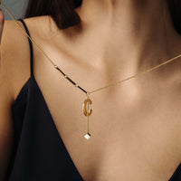 Thumbnail for Simple Initial Necklace worn by a woman, featuring gold elegance and minimalist design by Brother & Sisters.