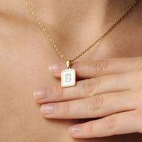 Thumbnail for Happiness Initial Necklace featuring a gold 'S' initial pendant worn by a woman, by Brother & Sisters.