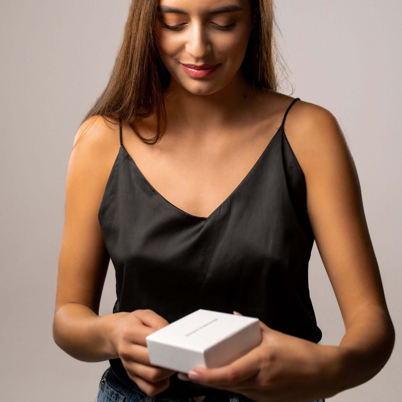 Eternal Photo Necklace gift box being opened by a woman, showcasing its elegant design by Brother & Sisters.
