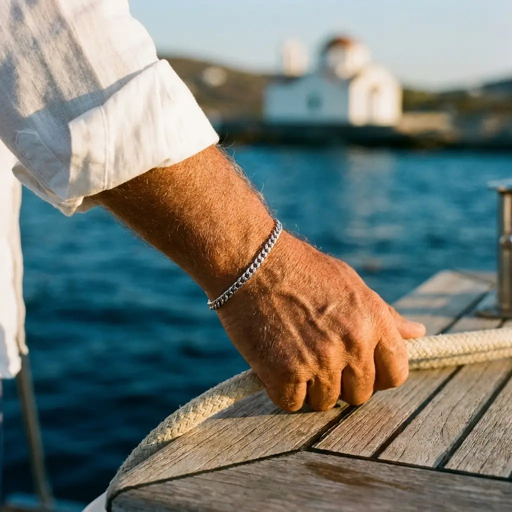 Older Mediterranean man on yacht wearing His silver Heart Bond bracelet, Greek isles
