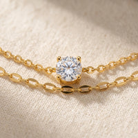 Thumbnail for Amalfi Layered Anklet CZ solitaire macro — round crystal in 4-prong gold claw setting between cable and marquise chains on cream linen, sparkling diamond-like center