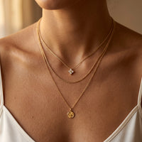 Thumbnail for Crystal Flower necklace layered with rope chain and disc pendant on Italian model décolleté — dainty signature in multi-necklace stack, quiet luxury styling