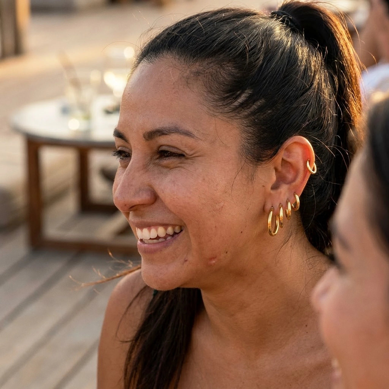 Huggie Hoop Earrings Set of 4 Pairs in Gold worn outdoors, lifestyle shot | SKU: huggie-set-gold