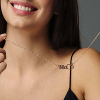 Thumbnail for A woman showcasing the Kitty Name Necklace with her name 'Mia' in stylish font, from Brother & Sisters.