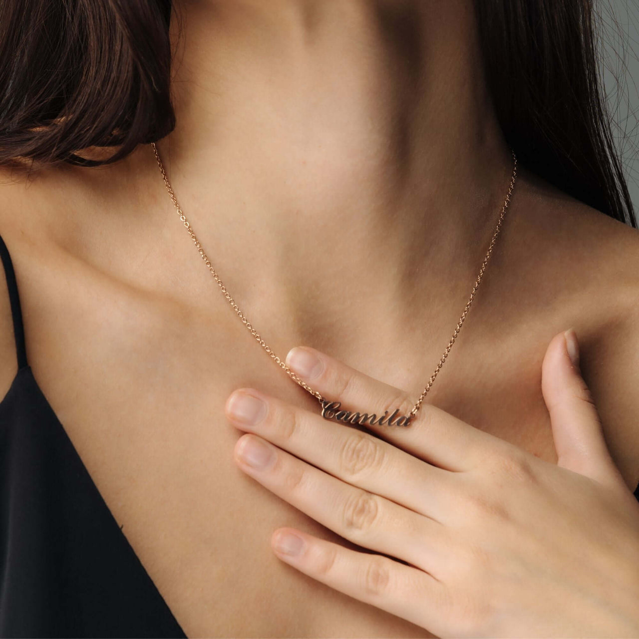 Minimalist Name Necklace by Brother & Sisters displayed elegantly on model, featuring the name 'Camila' in sleek, gold design.