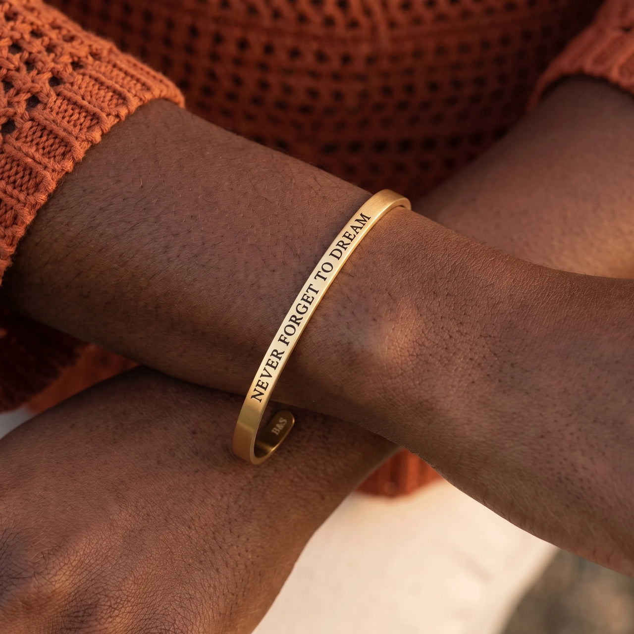 Close-up of the Never Forget To Dream bracelet in gold worn | SKU: nftd-g