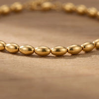 Thumbnail for Oval Bead Anklet featuring tiny gold beads with a smooth, tactile finish by Brother & Sisters.