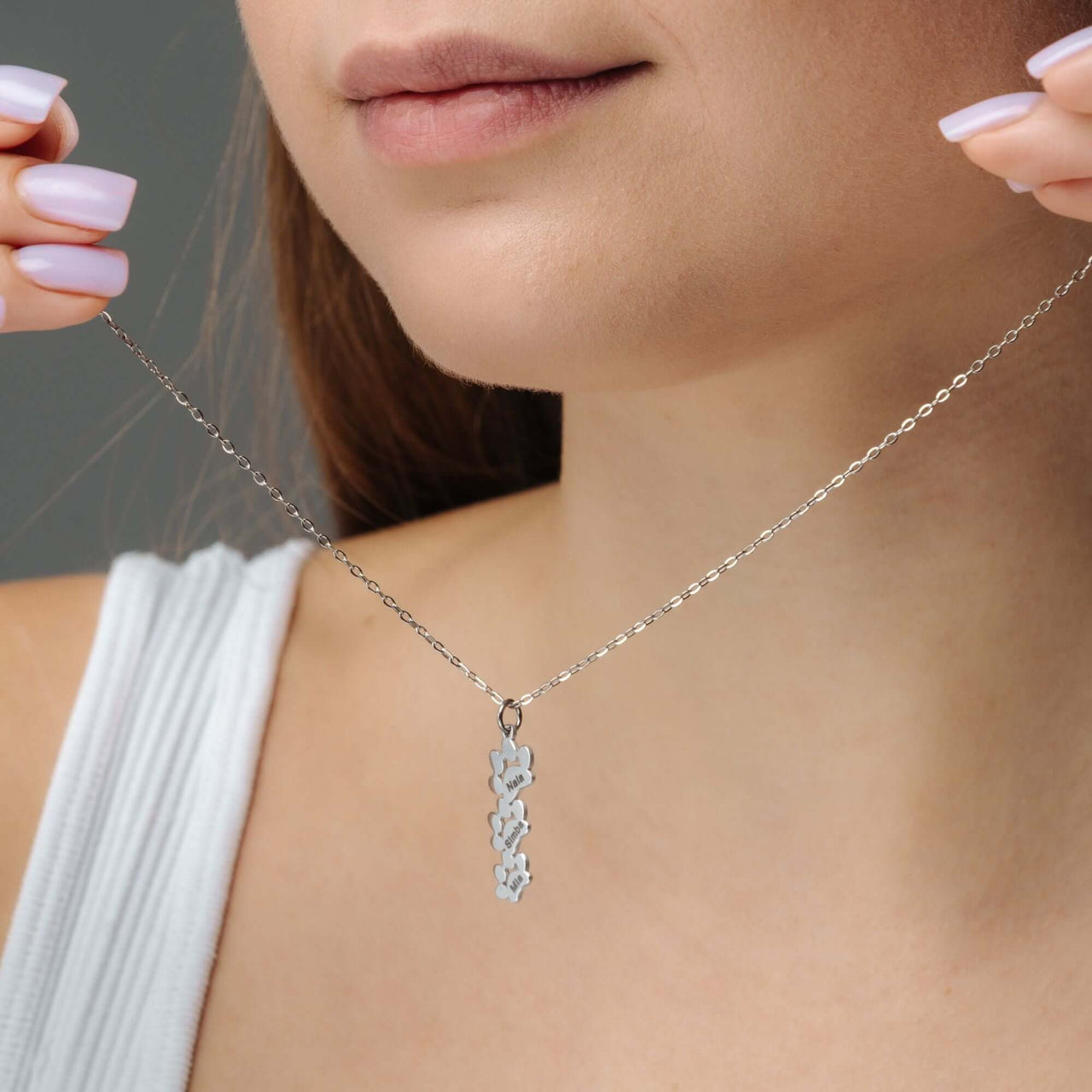 Model wearing a Paw Name Necklace by Brother & Sisters, showcasing its elegant design and personalized charm.