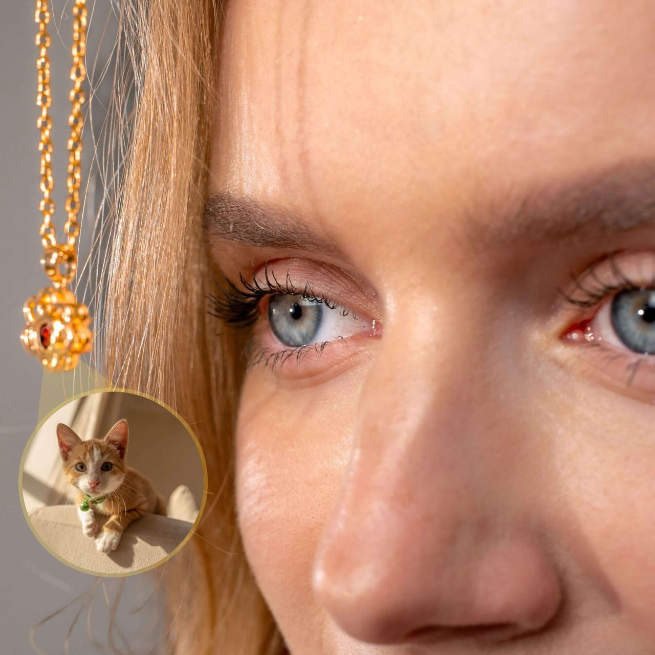 Close-up of a woman wearing a Paw Print Photo Necklace by Brother & Sisters with a photo projection of her pet.