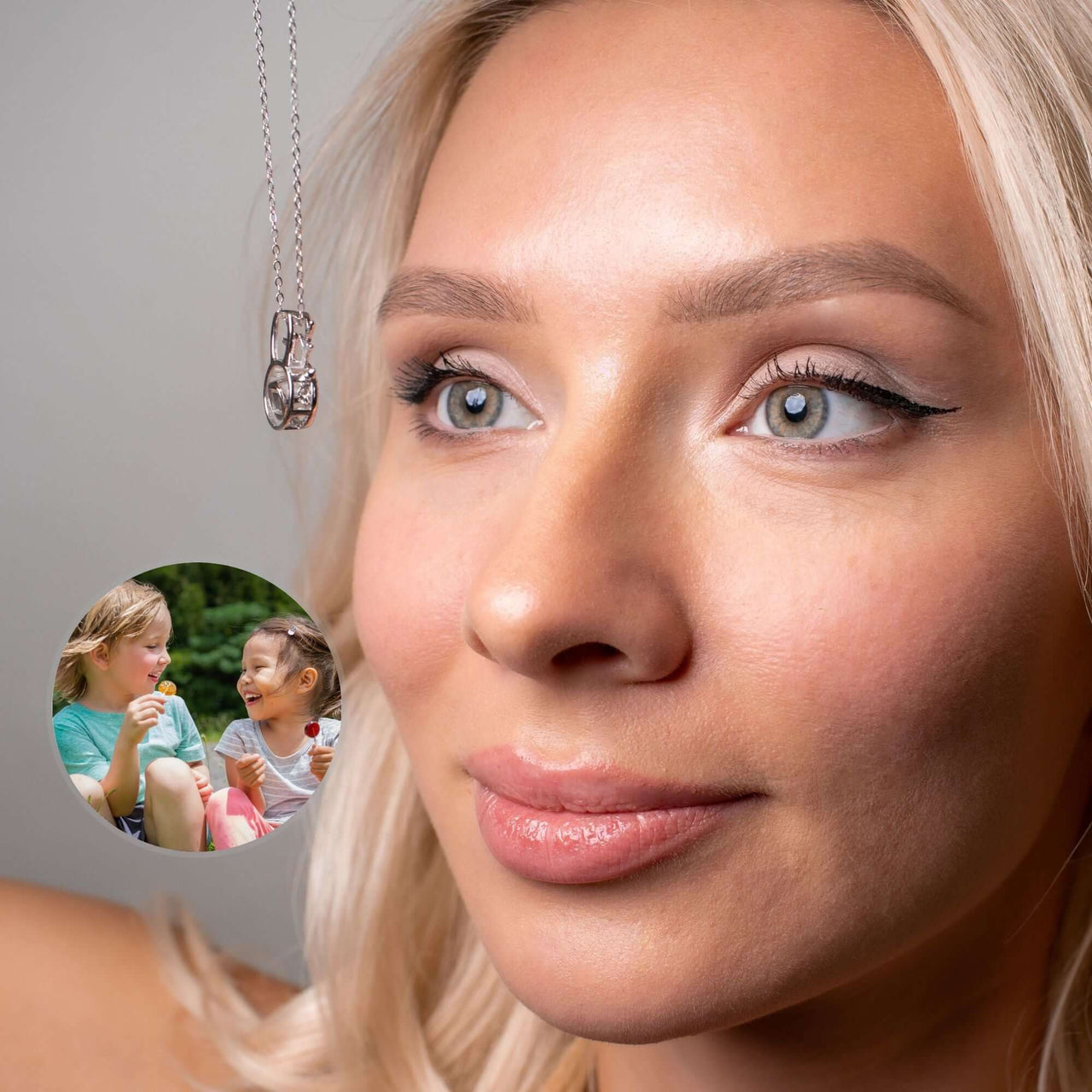 Person wearing a Reindeer Photo Necklace by Brother & Sisters featuring a photo insert for personalization.