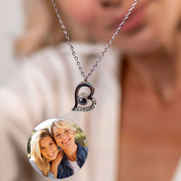 Thumbnail for Close-up of a Romantic Photo Necklace featuring a heart pendant with a personalized photo projection by Brother & Sisters.