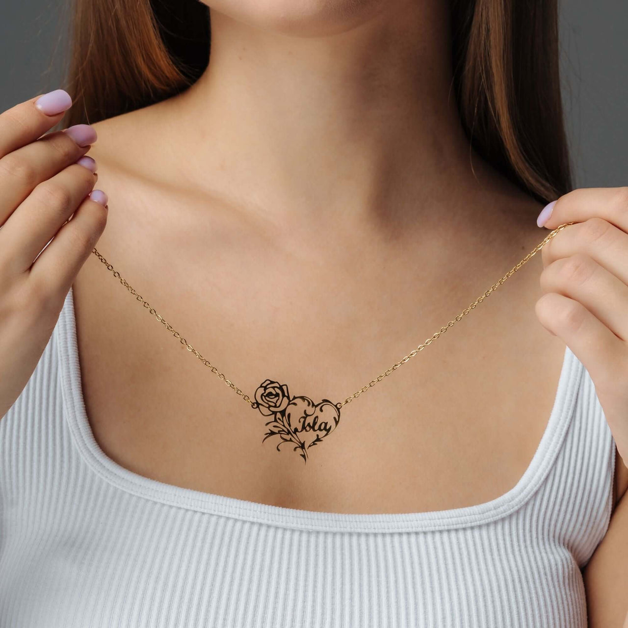 Model showcasing the Rose Name Necklace in gold, featuring a rose design and personalized name element by Brother & Sisters.