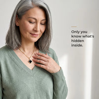Thumbnail for Grey-haired woman in a sage sweater touching the black clover pendant on its gold chain, only she knows the photo inside | SKU: TPH-CLVN-GOLD