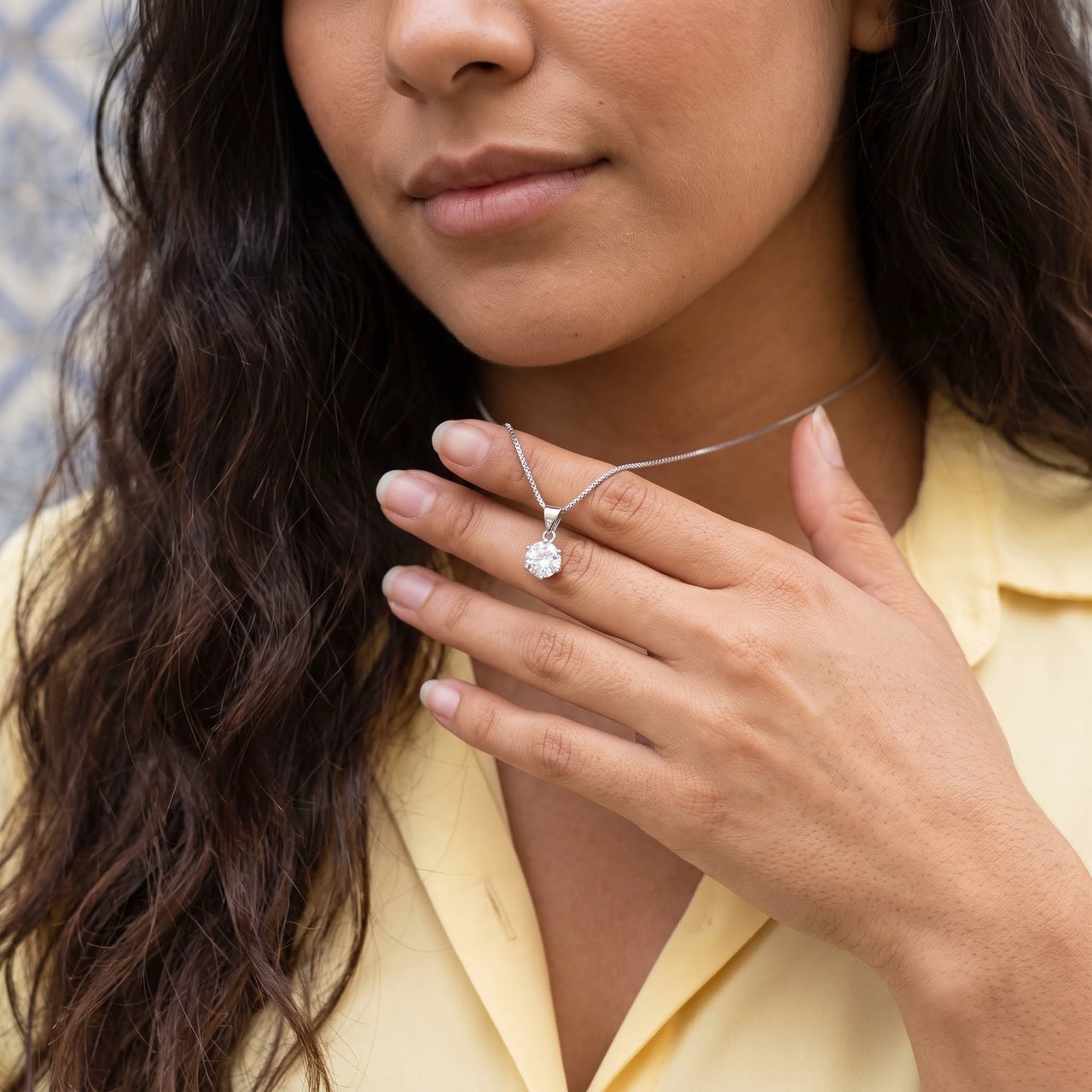Woman gently touching her silver necklace | SKU: 505665
