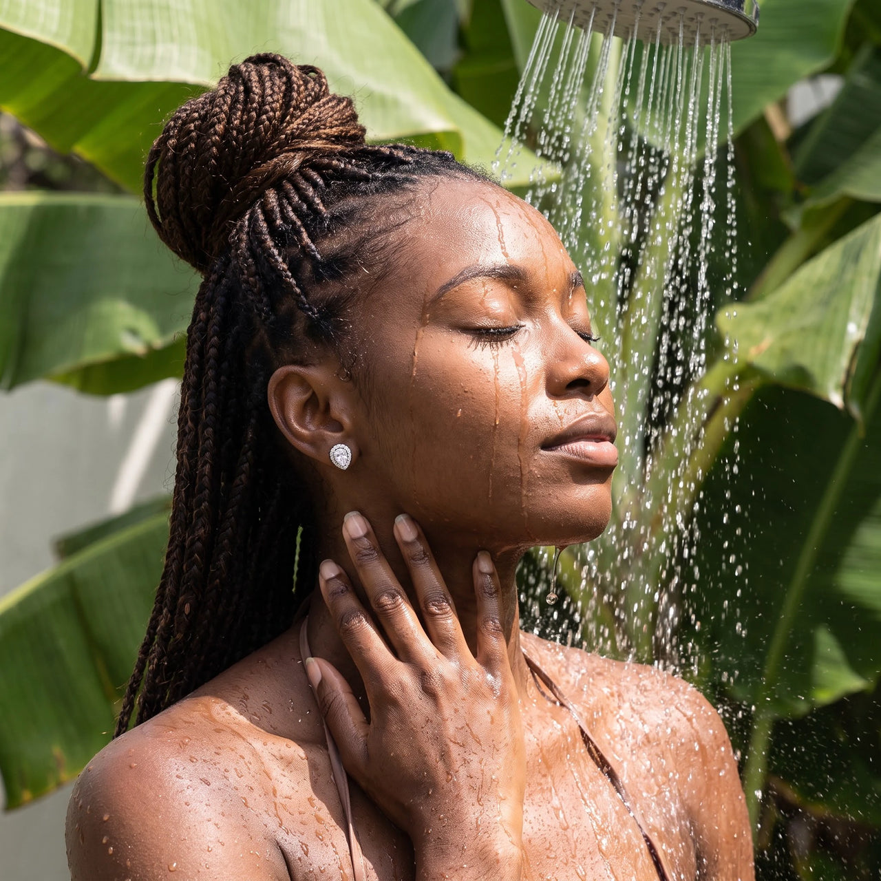 Silver stud earrings worn under a tropical outdoor shower | SKU: 505174