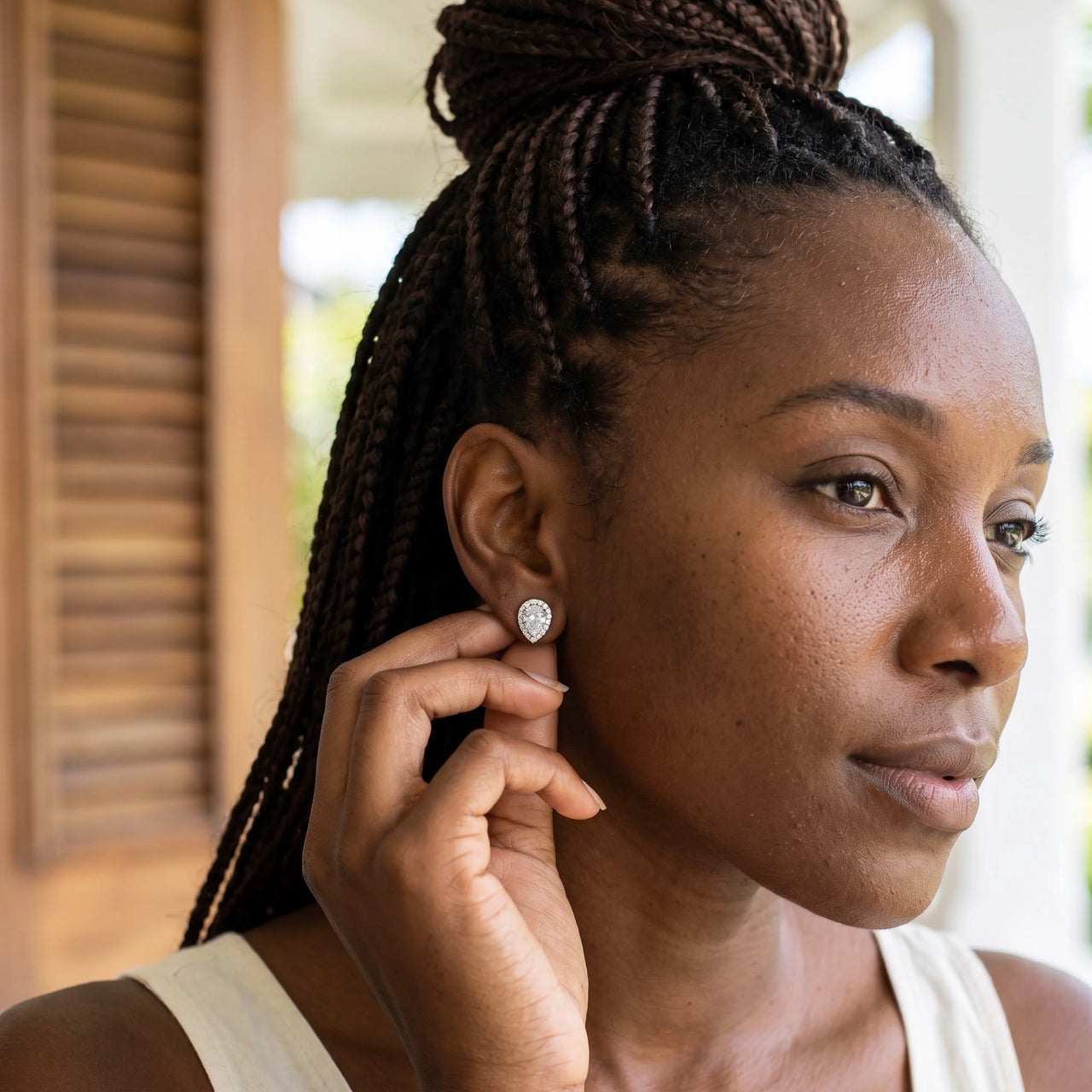 Woman gently touching her silver stud earrings | SKU: 505174