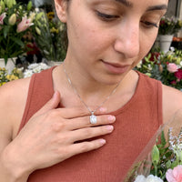 Thumbnail for Woman gently touching her silver necklace | SKU: 22559056