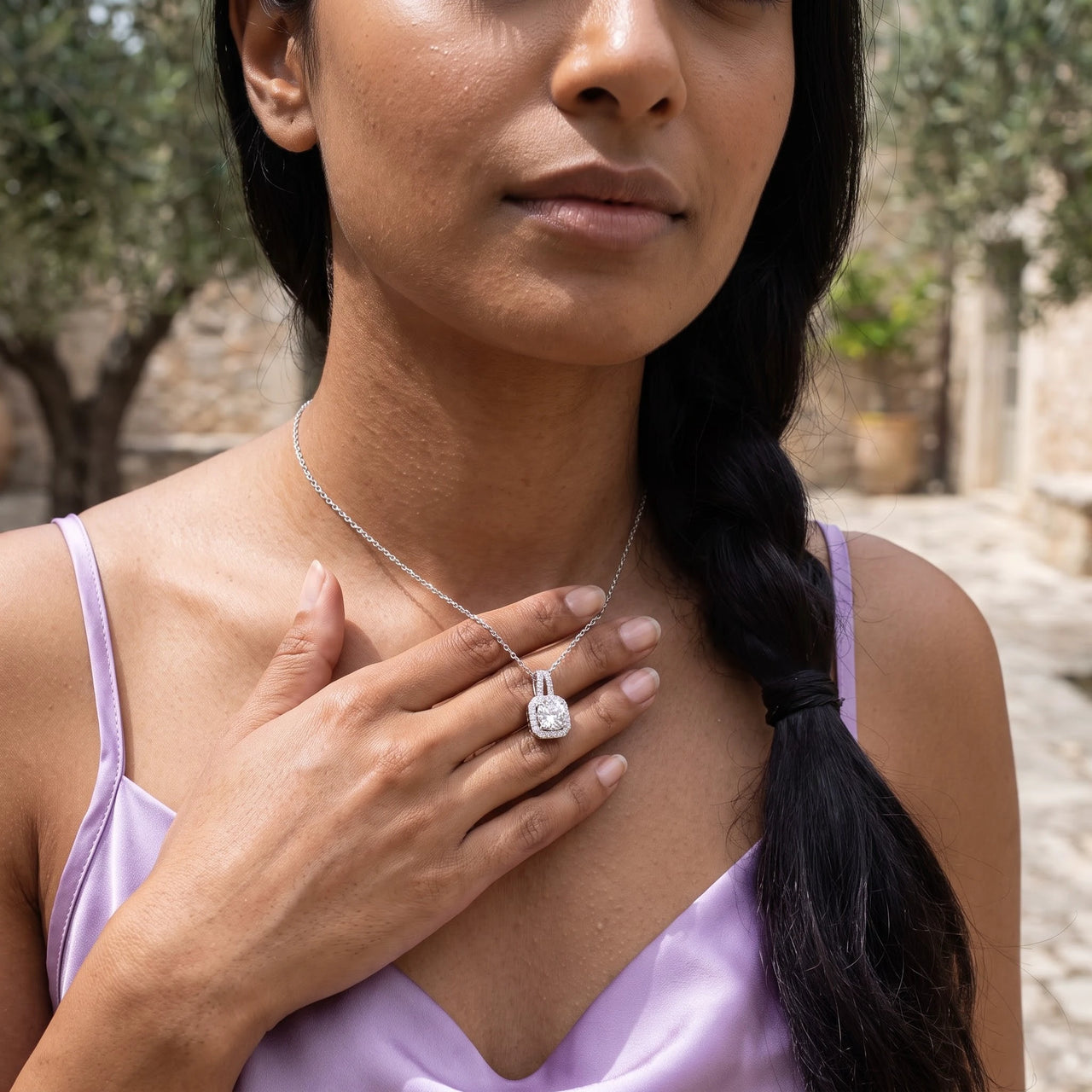 Woman gently touching her silver necklace | SKU: 505762