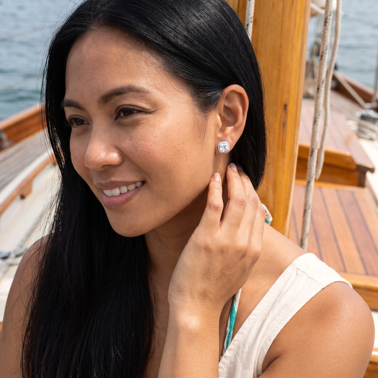 Woman relaxing on holiday wearing the silver stud earrings | SKU: 505185-white
