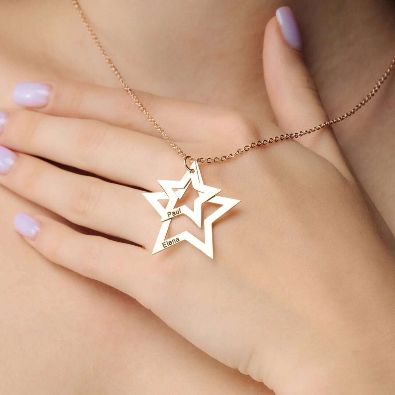 Stars Name Necklace by Brother & Sisters featuring a personalised design with names Paul and Elena in elegant star shapes.