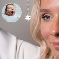 Thumbnail for Close-up of a woman wearing a Sun Photo Necklace by Brother & Sisters, showcasing a cherished baby photo.