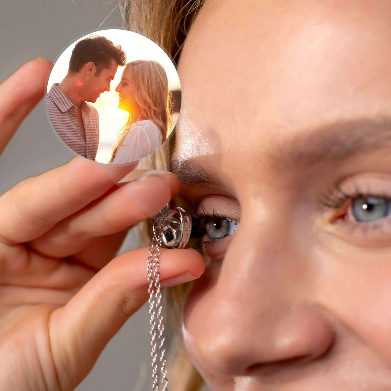 Woman holding a Timeless Photo Necklace featuring a couple's photo, showcasing love and memory by Brother & Sisters.