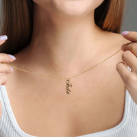 Thumbnail for Vertical Name Necklace worn by a woman, featuring a personalized gold pendant displaying the name 'Pade' by Brother & Sisters.