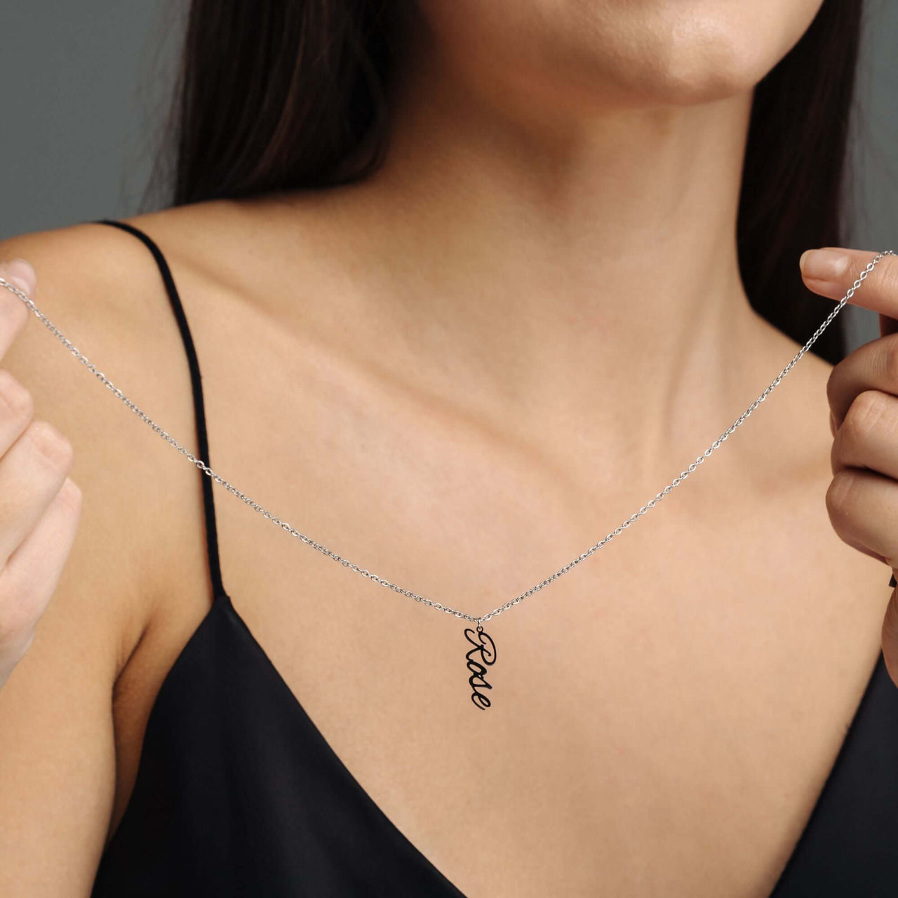 Vertical Name Necklace displayed by a model, featuring the name 'Rose' in a chic vertical design by Brother & Sisters.